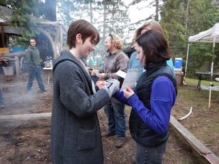 One of our graduating ambassadors presenting a braided cedar bracelet to an alumni.