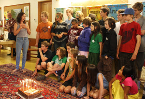 Zoe Miles presents a Forest Alphabet cake (baked by Trude) to youth artists